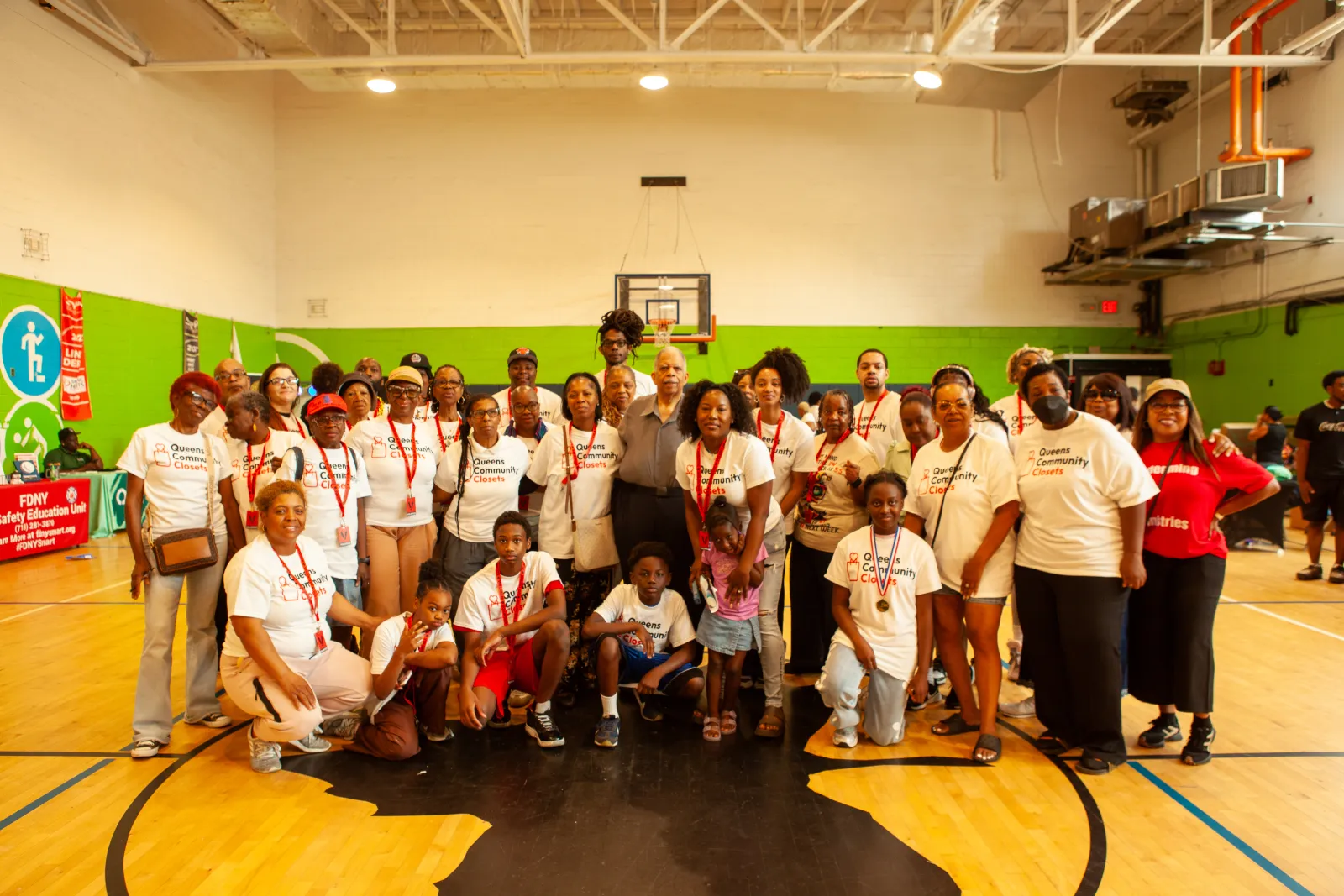 The full team of Queens Community Closet volunteers gathered at the launch event